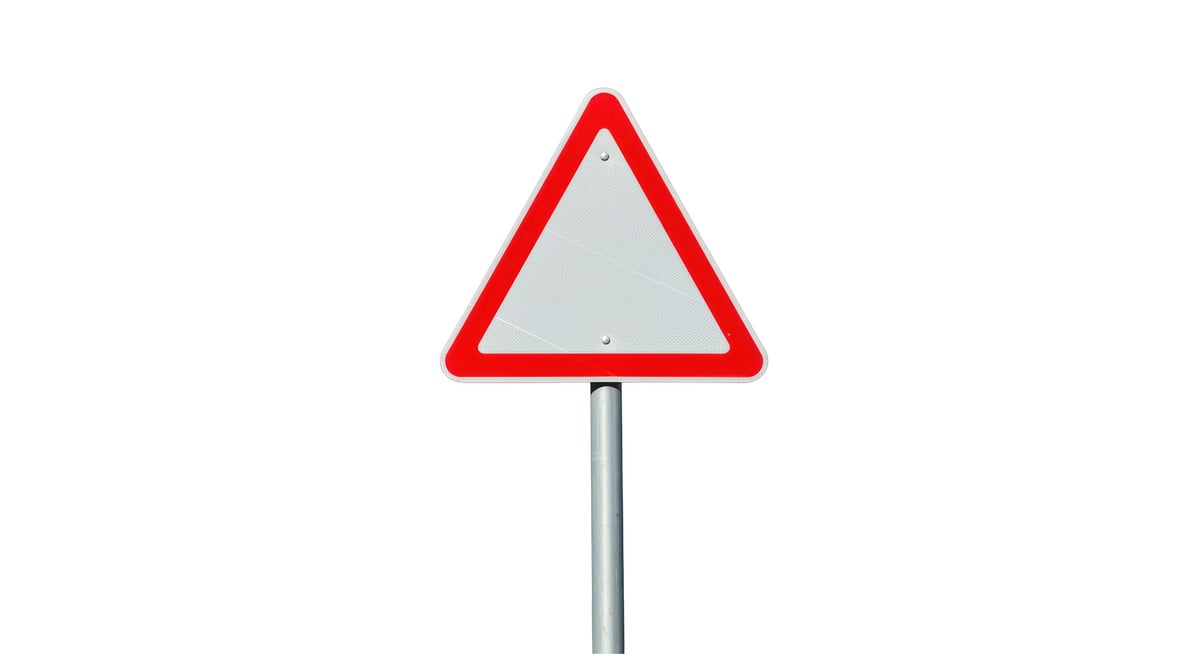 Isolated Empty Triangular Road Sign with Red Border and Metal Pole
