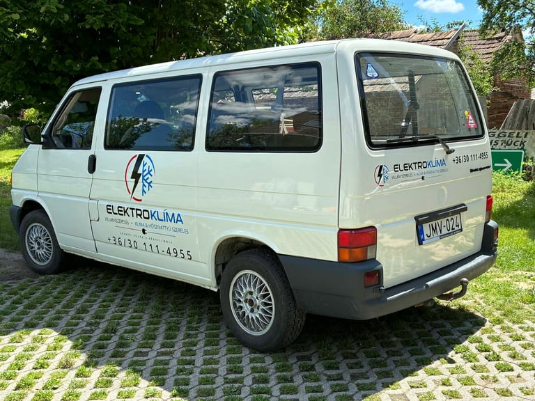 White Electrolima service van parked on paved driveway with green grass and trees in background